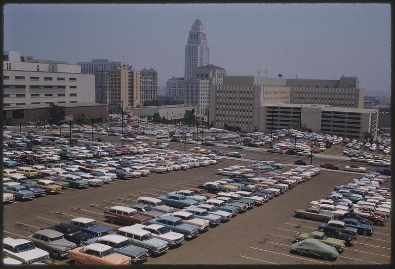 A color view of downtown Los Angeles in 1962, with parking lots, buildings and City Hall.