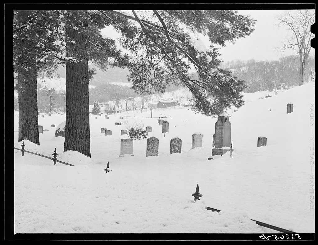 A small country cemetery in a Vermont winter, with old headstones.