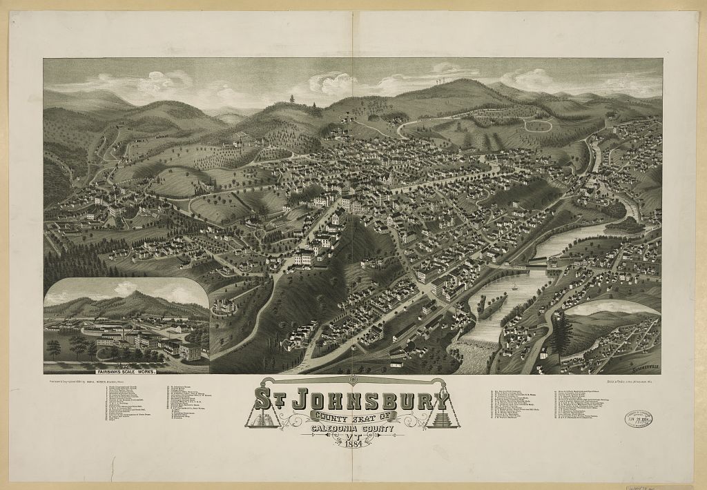 A bird’s-eye view of a Vermont town in a river valley, with church steeples, mills and rows of houses.