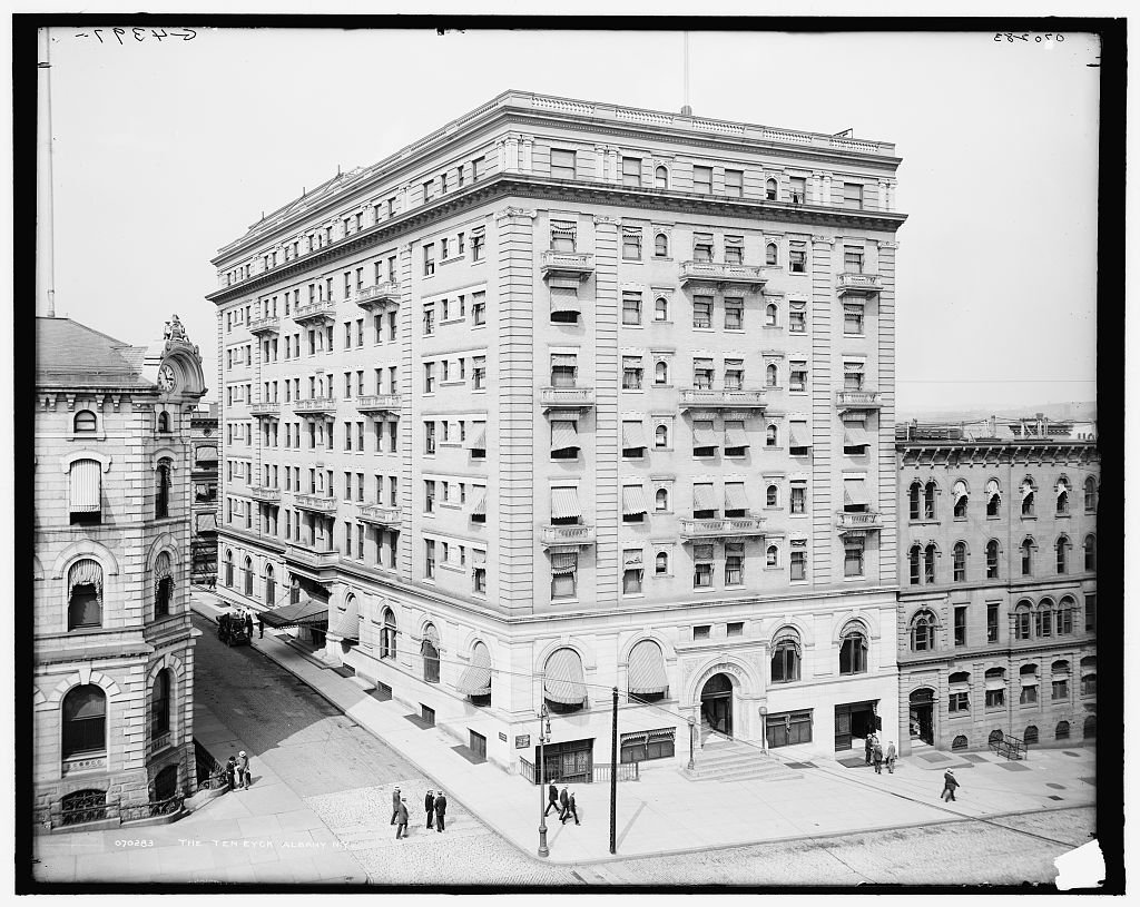 A tall hotel building on a city street corner, about 1908.