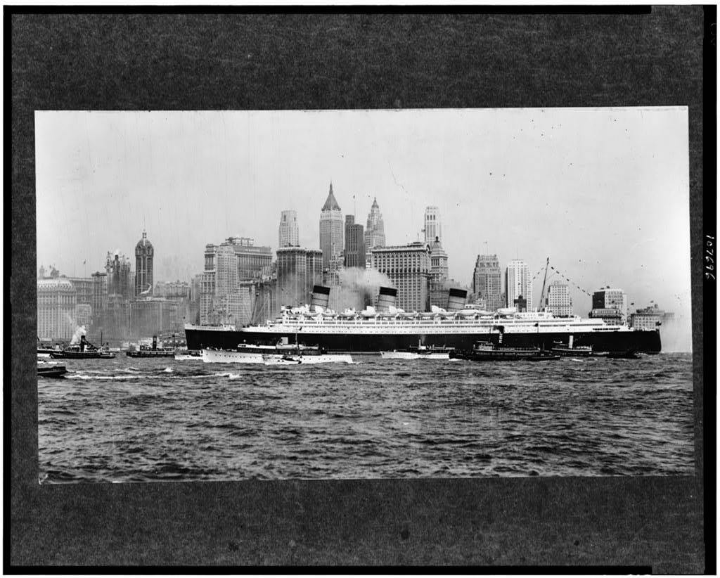The liner Queen Mary in New York harbor, with the city’s skyline behind.